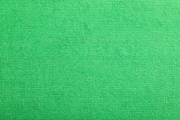 Light green microfiber cloth as background, top view