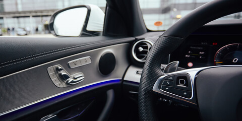 Fototapeta na wymiar Control buttons on steering wheel. Car interior.