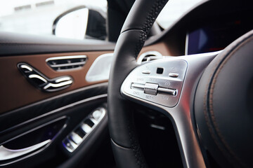 Control buttons on steering wheel. Car interior.