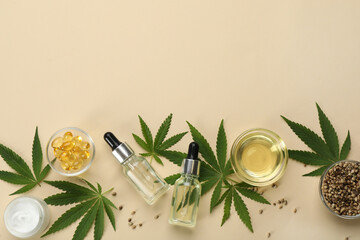 Fototapeta na wymiar Flat lay composition with hemp leaves, CBD oil and THC tincture on beige background, space for text