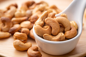 Roasted cashew nuts in white bowl,Healthy snack Delicacies food.