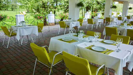 terrace summer cafe with tables and chairs for people, an empty institution for recreation, nobody