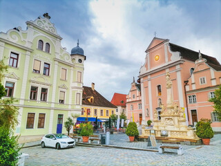 The main square with old buildings and Parish Church in the charming little town of Frohnleiten in the district of Graz-Umgebung, Styria region, Austria