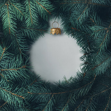 Silhouette of a Christmas ball made of pine branches. Creative Christmas layout.