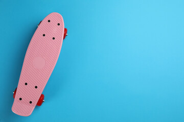 Skateboard on light blue background, top view. Space for text