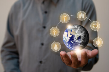 Close up man holding planet Earth as a green and dry.Renewable energy efficency and Environmental biodiversity concept.Elements of this image furnished by NASA
