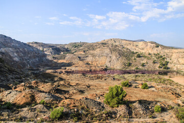 Fototapeta na wymiar La Union Mining Park and ocher-tinted water lake