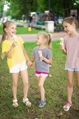 Little Girls Walking Outside In Park Eating Ice Cream. Siblings Eating Ice Cream And Laughing