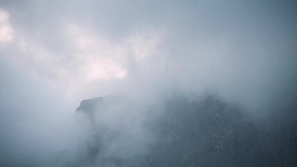 Close up shot of top of Girnar mountain covered with beautiful clouds during monsoon season. At Junagadh, Gujarat, India