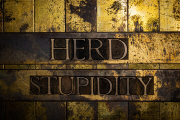 Herd Stupidity text on grunge textured copper and gold background