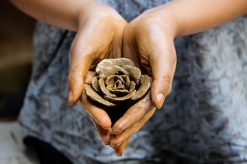 Girl holding mud rose