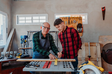 father and son in their carpentry workshop