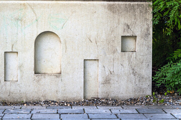Sketch of the door and windows in the concrete wall. Next to the sidewalk and dereries.