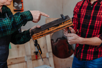 father and son in their carpentry workshop, danger, misuse of tools