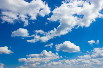 Fototapeta na wymiar White clouds on blue sky in bright sunny weather
