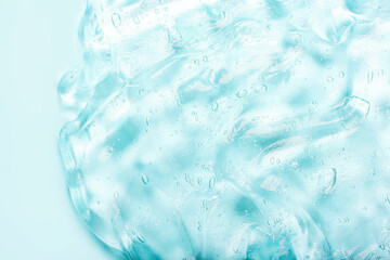 Transparent blue moisture face serum, hair gel with bubbles smeared. Cosmetic products for makeup and skin care. Hydrating hyaluronic acid. Cosmetology.