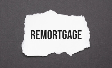 remortgage sign on the torn paper on the black background