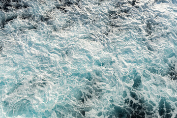 Fototapeta na wymiar Sea water surface with waves from a cruise ship wake.