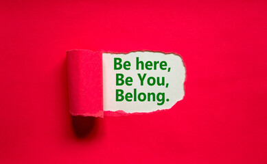 You belong here symbol. Words 'be here, be you, belong' appearing behind torn purple paper. Purple background. Business, diversity, inclusion, belonging and you belong here concept, copy space.