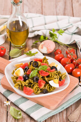 Fusilli pasta with cherry tomatoes, eggs and black olives.