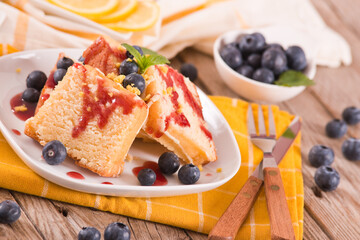 Lemon pund cake with blueberries and strawberry syrup.