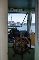 rudder of a boat, where maritime navigation takes place, the rudder is shaped in wood hinged to the stern of the boat. the seat of the captain or skipper © rikstock