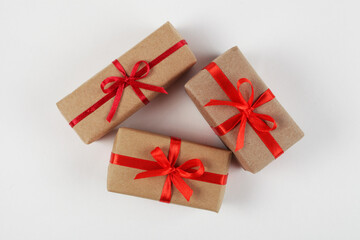 Christmas gifts with red bow isolated on white background, top view, close-up
