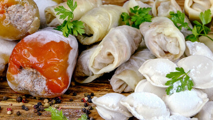 Frozen semi-finished products, stuffed bell peppers, cabbage rolls and dumplings lies on counter in market or on table in the home kitchen. Dolly shot. Close-up.