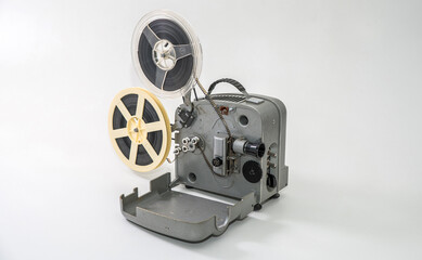 Old vintage film projector for watching films on film strip on a white background.