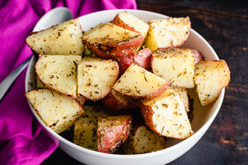 Tuscan Roasted Red Potatoes in a Serving Bowl: Roasted red potatoes coated in olive oil, spices,...