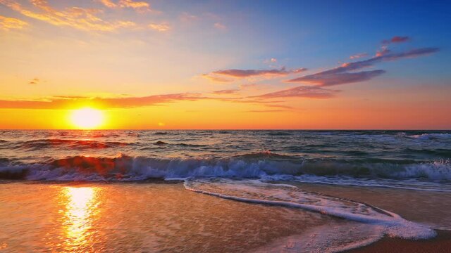 Golden sunrise over the sea and tropical beach, paradise island and waves