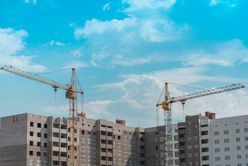 Fototapeta premium New house construction and cranes.