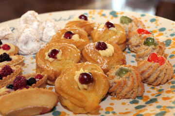 Zeppole di San Giuseppe and almond paste cookies. Typical sweets of southern Italy