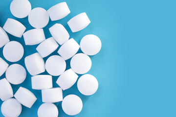 Naphthalene mothballs on blue backgrond.