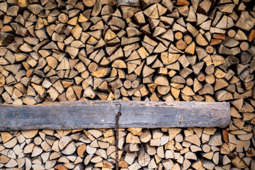 Wooden logs, beams, firewood, frame. A lot of wood. Wooden log wooden background. Fuel. Harvesting firewood.