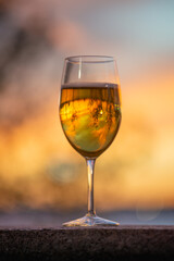 a glass of wine at sunset