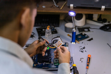 technician removing processor from motherboard