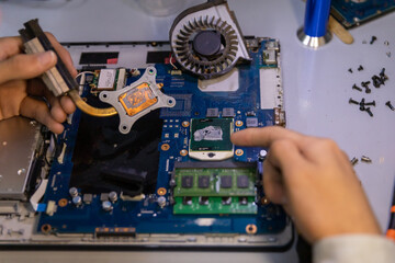 Fototapeta na wymiar technician removing processor from motherboard