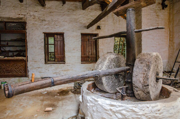 Ancient olive oil production machinery, stone mill and mechanical press, oil mill for olives. Abandoned old grinding stone in Mani, Laconia, Greece