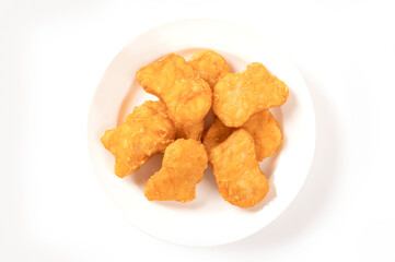 Chicken nuggets on white plate 