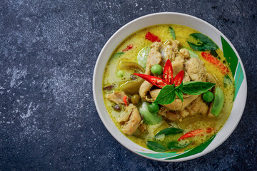 Chicken Green Curry In a white bowl circle on the table top Thai food concept.