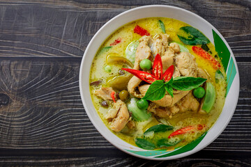 Chicken Green Curry In a white bowl circle on the table top Thai food concept.