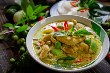 Chicken Green Curry In a white bowl circle on the table top Thai food concept.