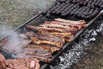 Traditional Argentine barbecue. Grilled beef, sausages and blood sausages. Grilled ribs. Roast done on grills on the floor. National and gaucho festivals. Traditional Argentine food. Grilled meat.