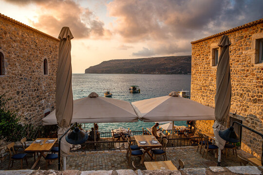 Tourists and visitors arrive at village Limeni, a famous coastal village with traditional houses and colorful stoned buildings in Limeni, Mani area, Laconia, Greece