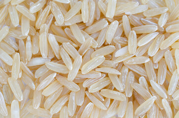Top view of dry organic brown rice background for clean food ingredient or agricultural product concept