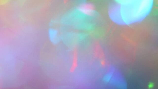 Iridescent holographic rainbow unicorn glow and bokeh. Festive abstract shiny blurry pink purple background