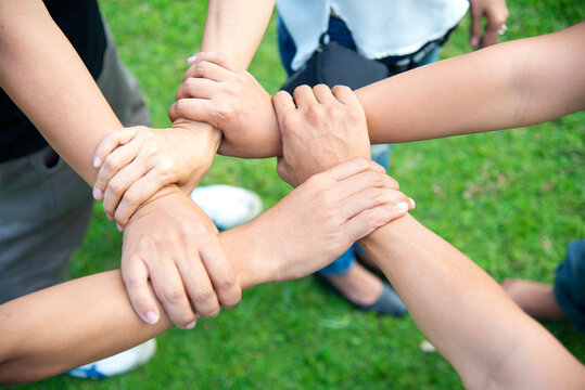 Solidarity unite people hands together community teamwork. Hands of spirit team working together outdoor. Unity strong handshake with people or agreement of feeling or happy diverse education action - Powered by Adobe