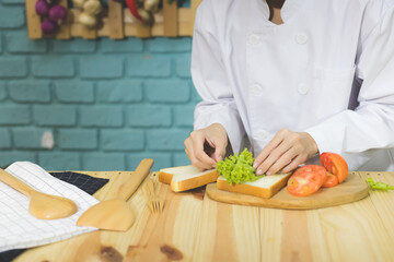 Chef is making sandwiches in the kitchen.
