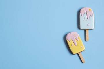 Flat lay of bright glazed cookies in the shape of ice cream.